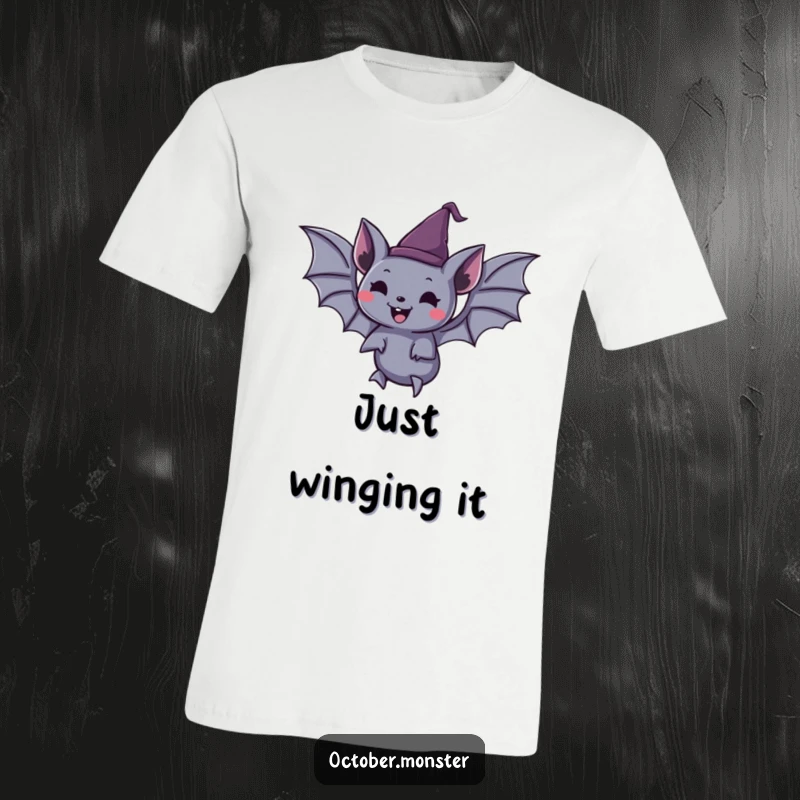 Funny spooky bat wearing a tiny pointed hat, joyfully floating, on a soft t-shirt, ideal for Halloween enthusiasts.